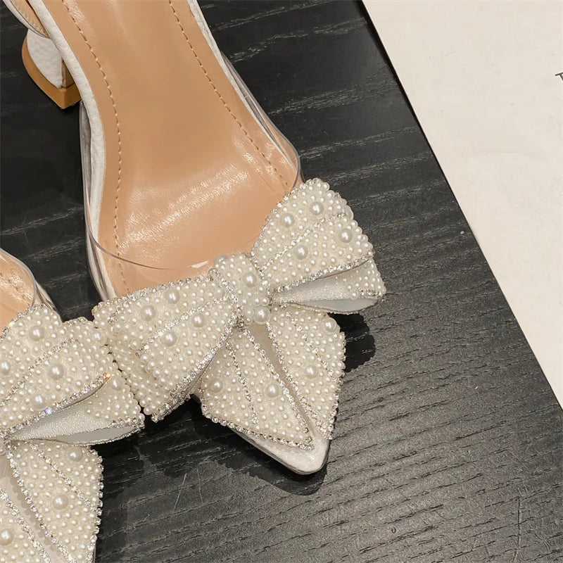 Liyke Fashion Design White Pearl Bowknot Women Pumps Sexy Pointed Toe High Heels Wedding Prom Shoe PVC Transparent Sandal Female
